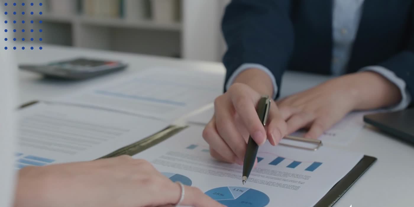 Brokers reviewing a client's risk report at a desk